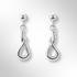 Pair of silver earrings on a light grey background