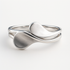 Silver ring with a modern design on a white background