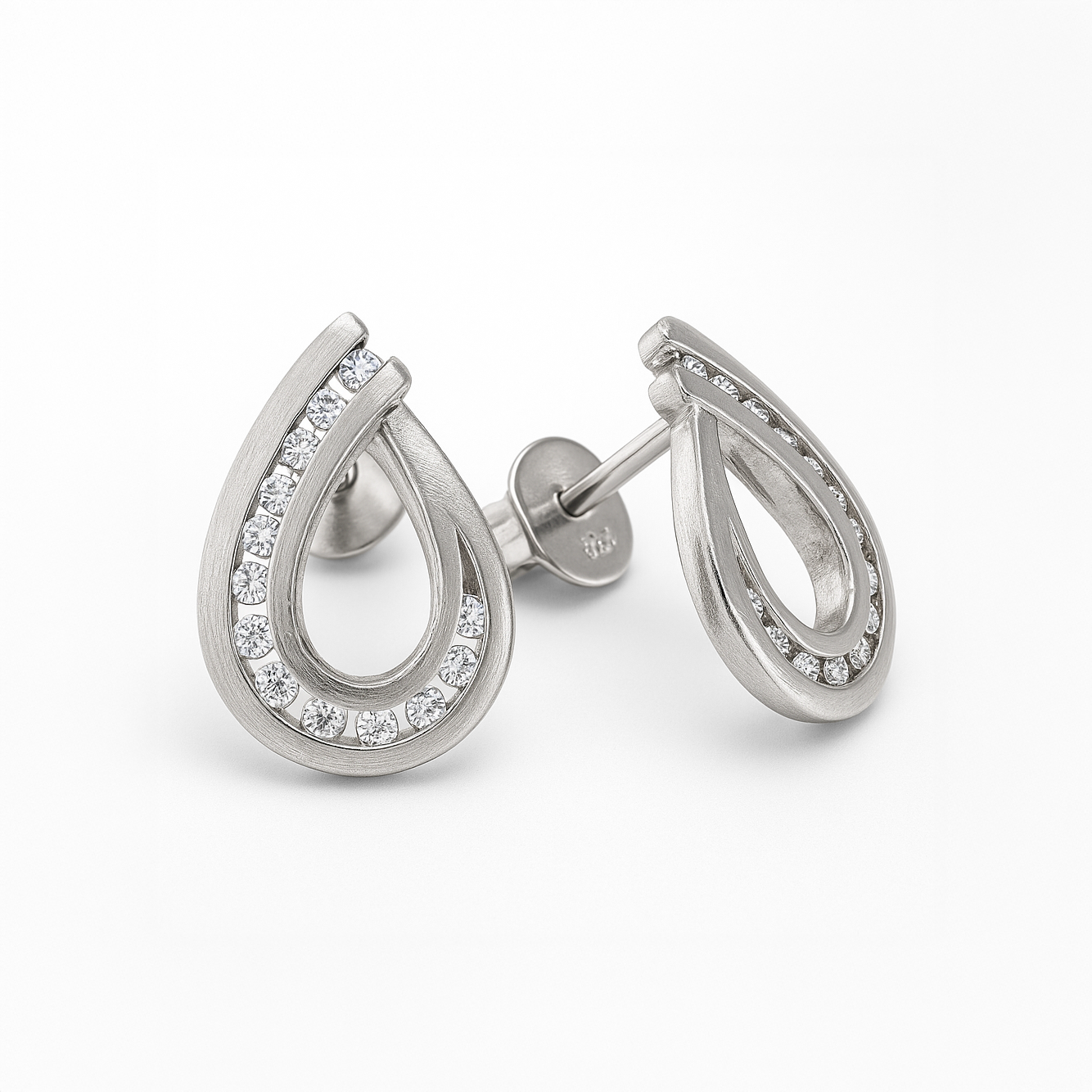 Pair of silver hoop earrings with clear gemstones on a white background