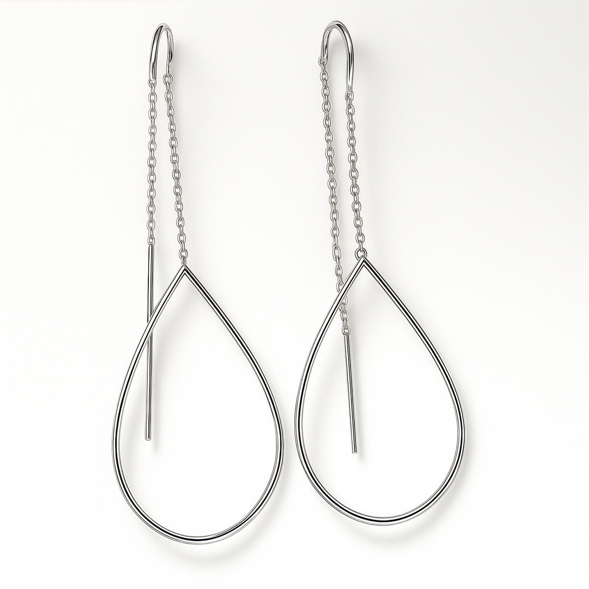 Teardrop-shaped silver earrings on a white background