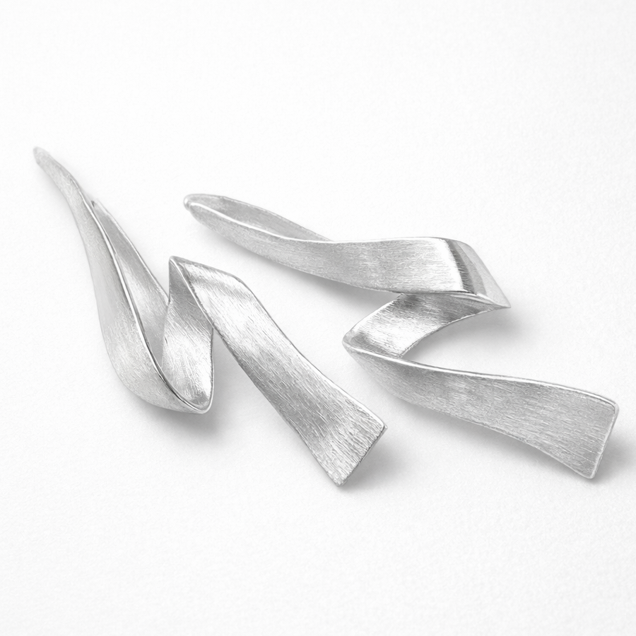 Silver abstract sculpture on a white background
