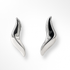 Pair of silver wing-shaped earrings on a white background