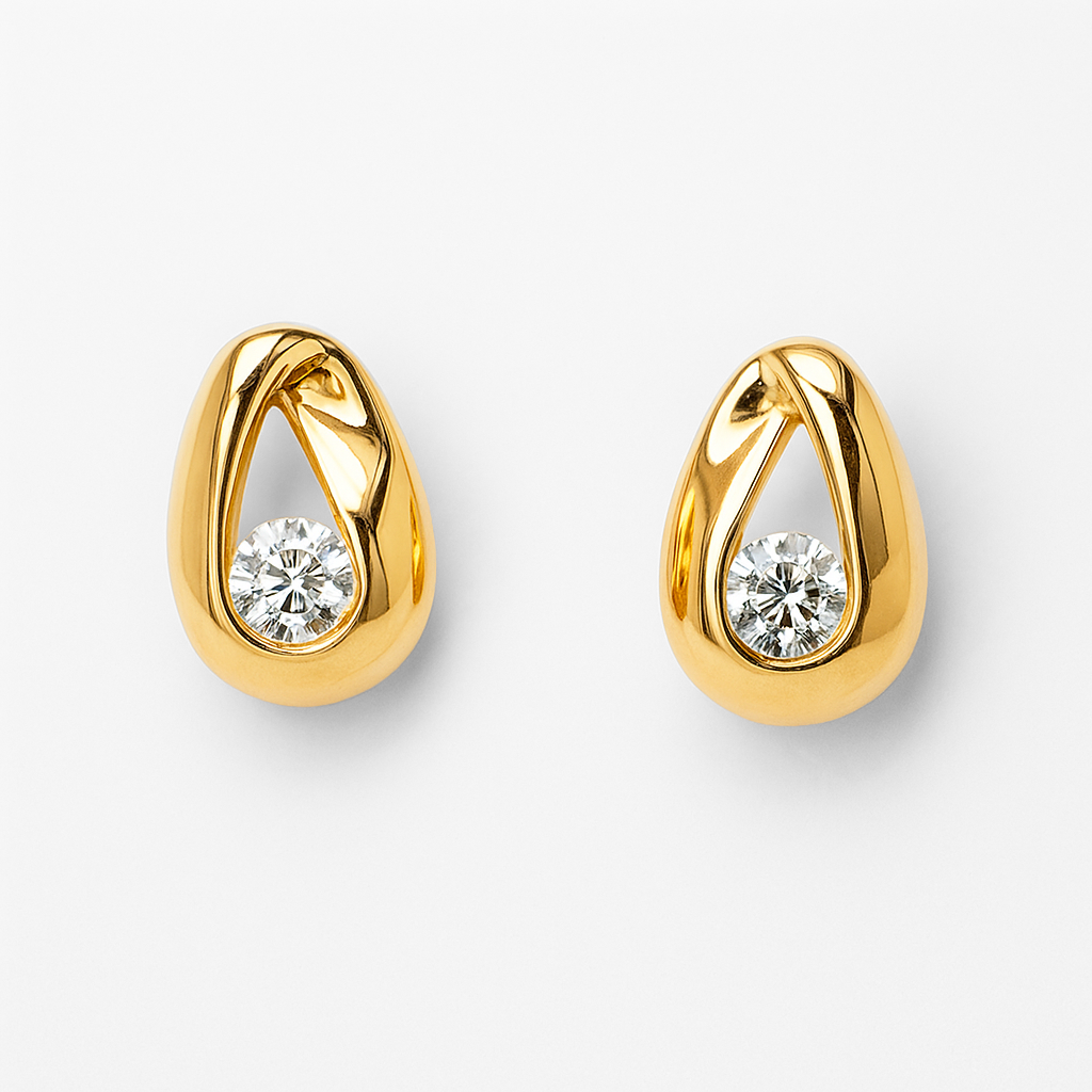 Gold earrings with clear gemstones on a white background
