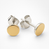Gold and silver stud earrings on a white background