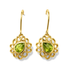 Gold earrings with green gemstones on a white background