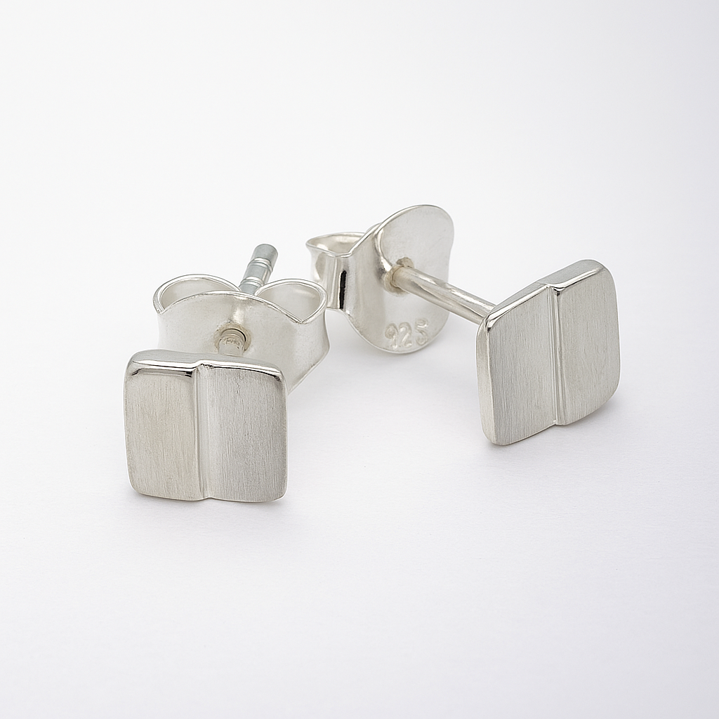 Pair of silver square stud earrings on a white background