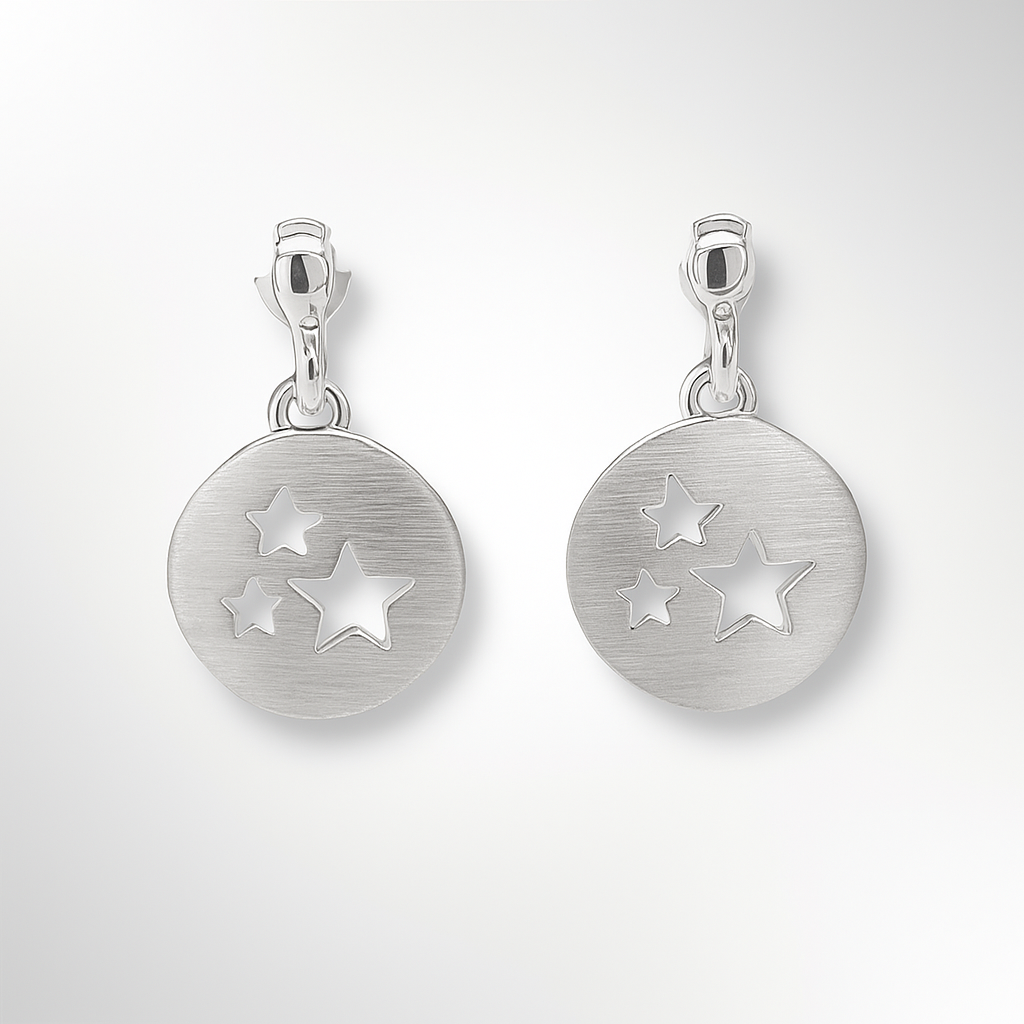 Pair of silver earrings with star designs on a white background