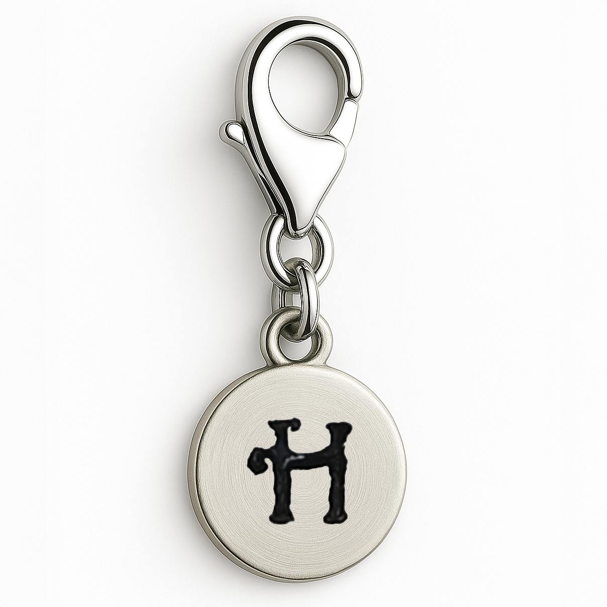Silver charm with letter 'H' on a white background