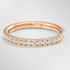Rose gold ring with diamonds on a light gray background