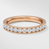 Rose gold ring with diamonds on a light gray background