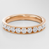 Rose gold ring with diamonds on a light gray background