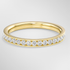 Gold ring with diamonds on a light gray background
