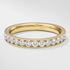 Gold ring with diamonds on a light gray background