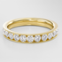 Gold ring with diamonds on a light gray background