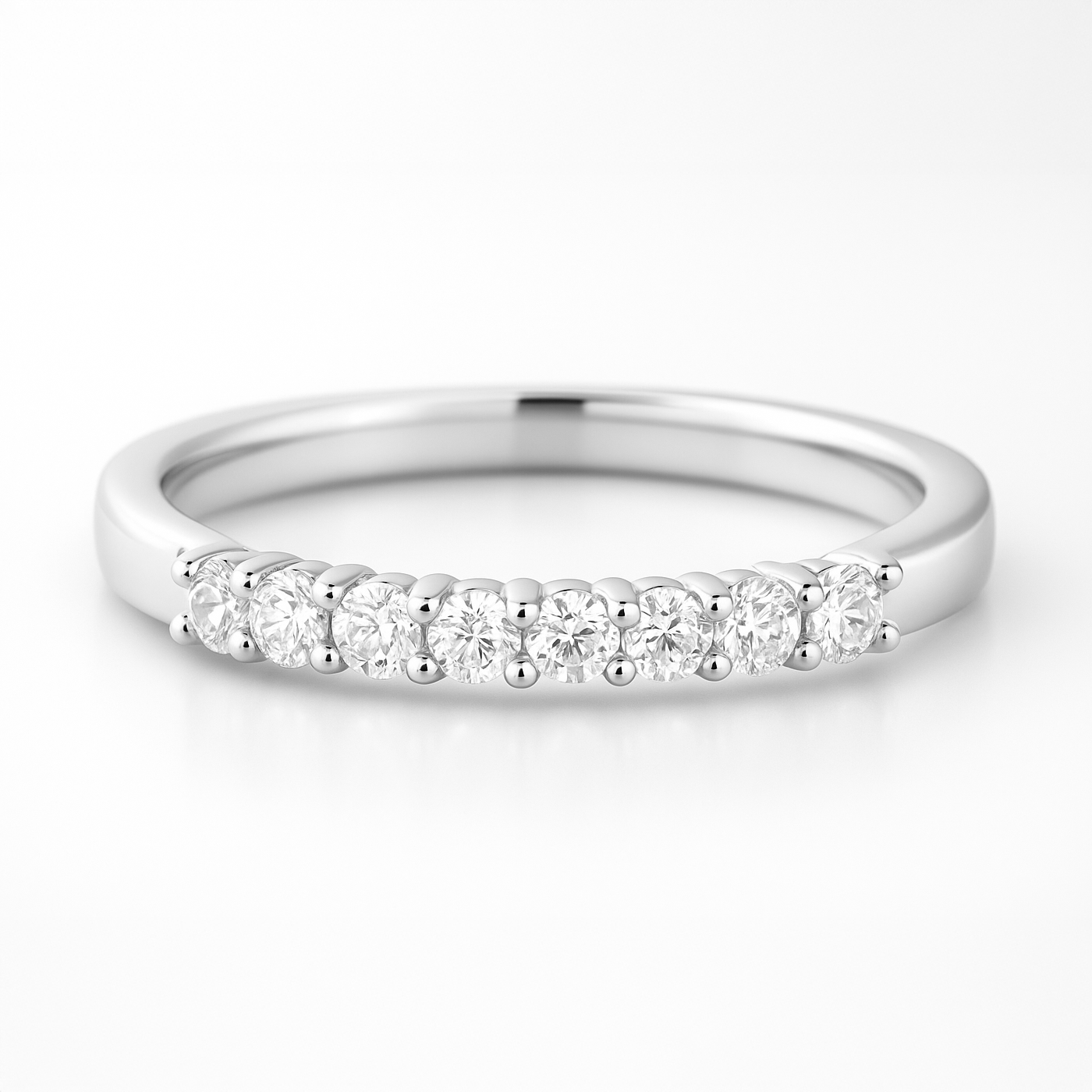 White gold wedding ring with small diamonds on a white background