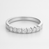 White gold wedding ring with small diamonds on a white background