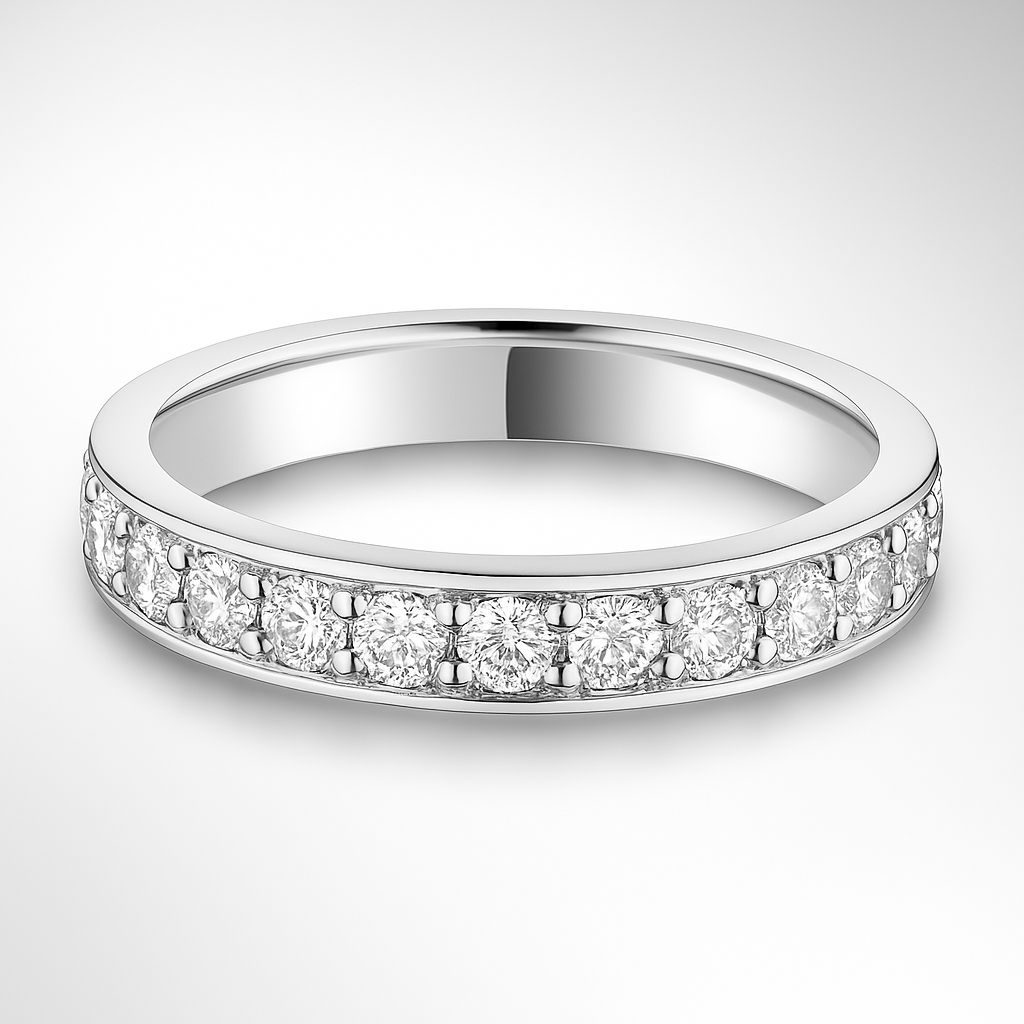 White gold wedding ring with small diamonds on a light grey background