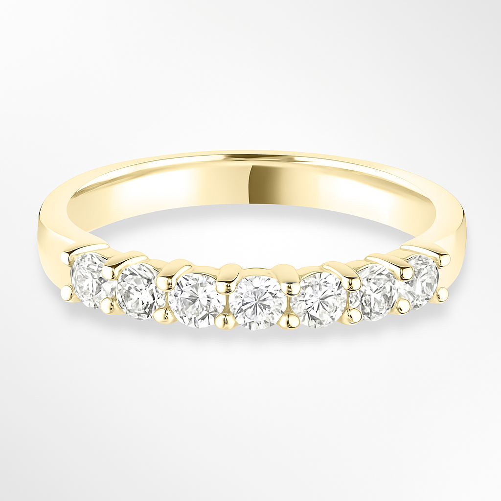 Gold wedding ring with diamonds on a white background
