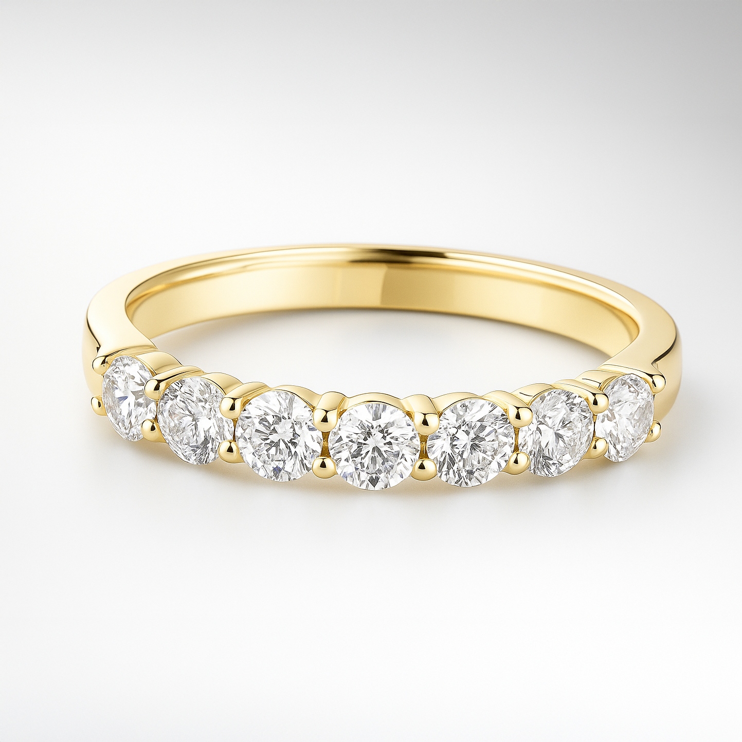 Gold wedding ring with diamonds on a white background
