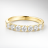 Gold wedding ring with diamonds on a white background