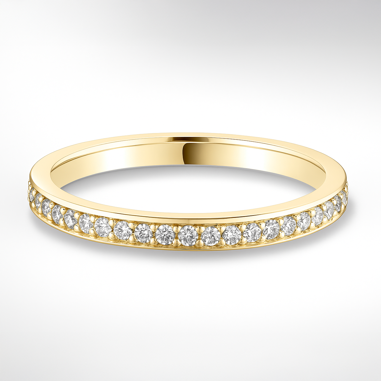 Gold wedding ring with diamonds on a white background