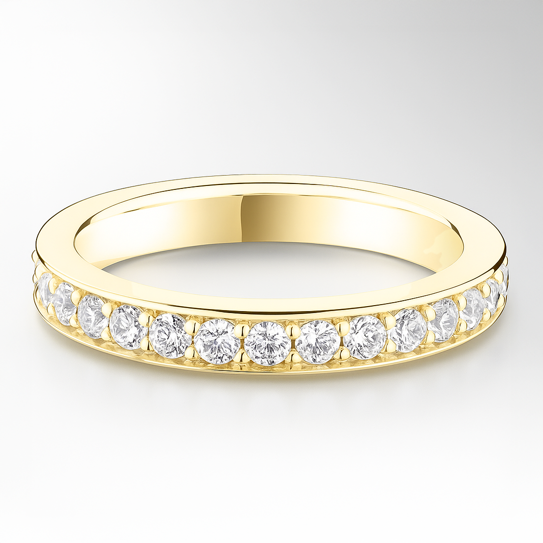 Gold wedding ring with diamonds on a light grey background