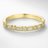 Gold ring with diamond accents on a white background
